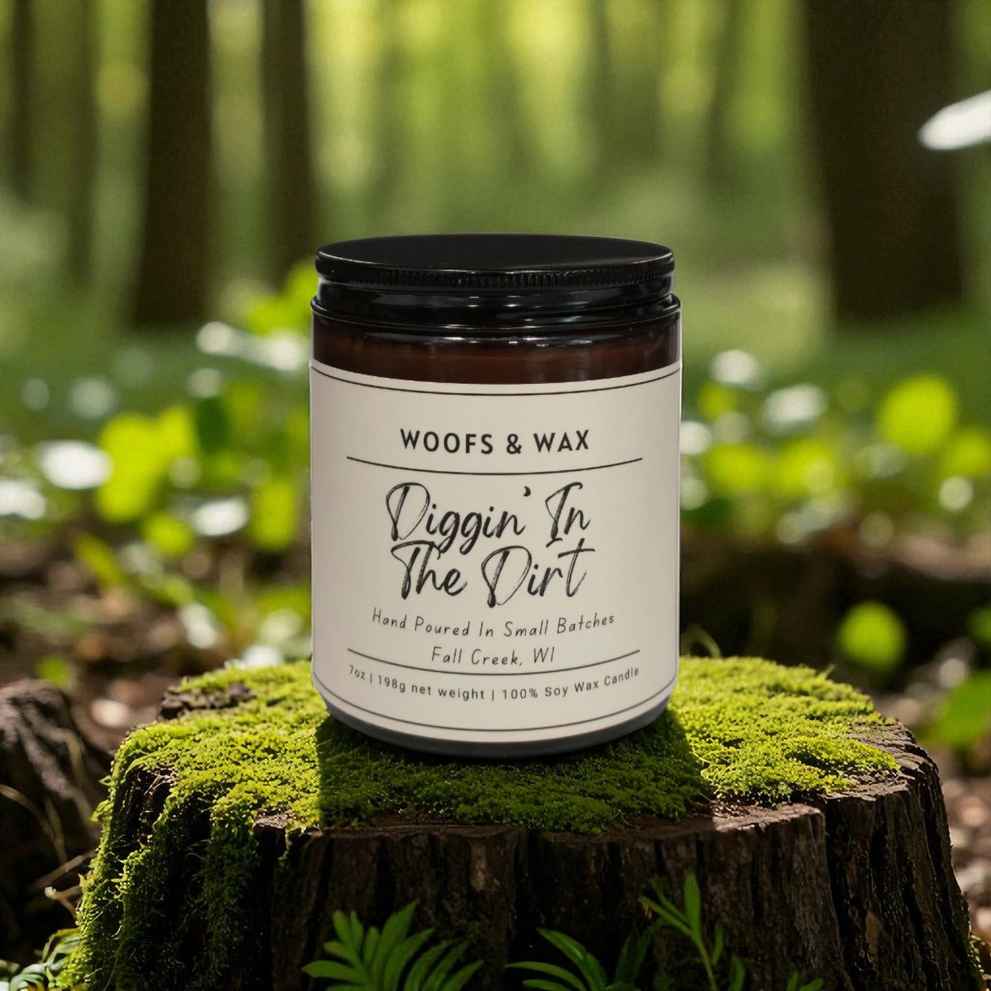 Candle jar labeled 'Woofs & Wax Diggin' In The Dirt' on a mossy log with a forest background