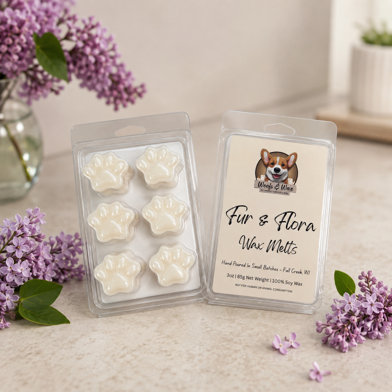 Fur & Flora wax melts packaging with paw-shaped melts and a dog illustration on a light surface with flowers.