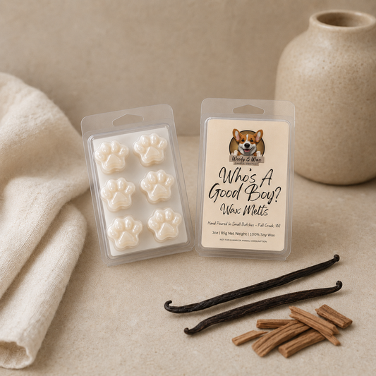 Packaged wax melts with paw prints, sandalwood and cinnamon sticks on a neutral background