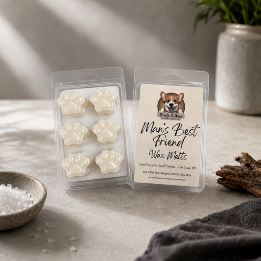 Wax melts with the name "Man's Best Friend" with an image of a dog on them, on a table with salt and wood.