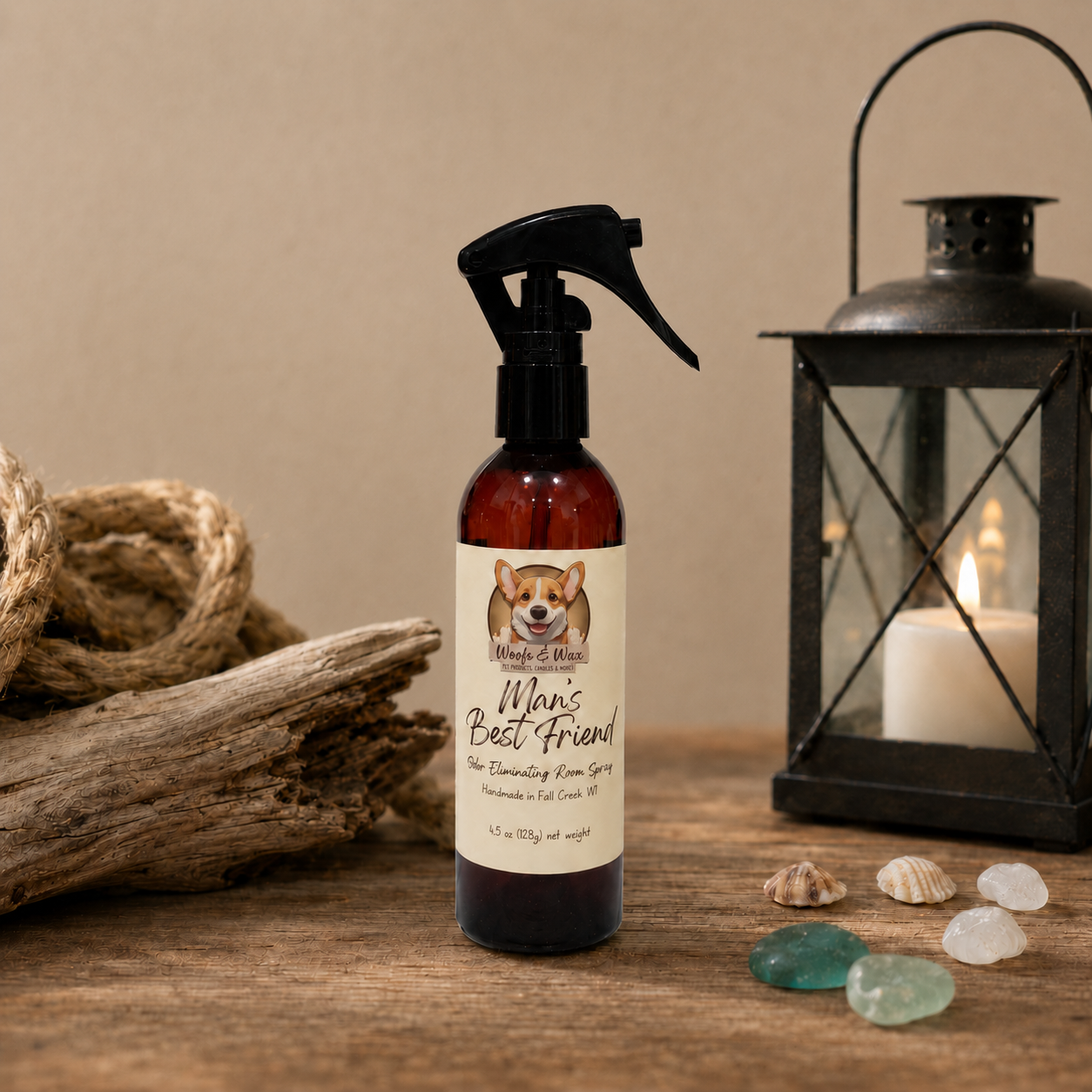 Bottle of 'Man's Best Friend' room spray on a wooden surface with a candle and lantern in the background.