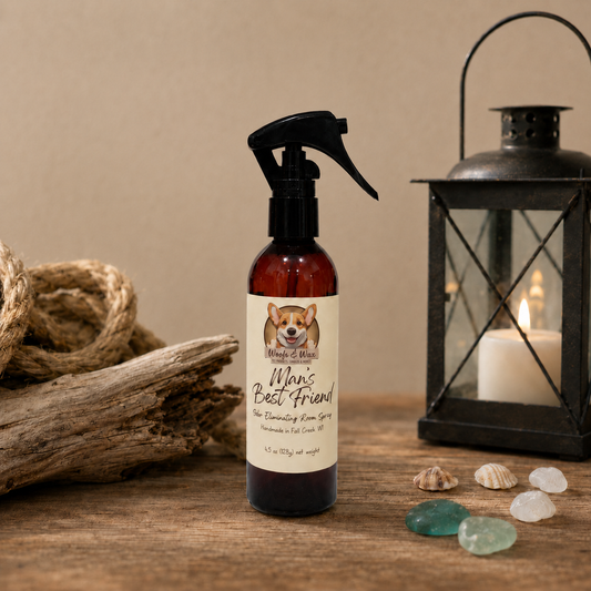 Bottle of 'Man's Best Friend' room spray on a wooden surface with a candle and lantern in the background.