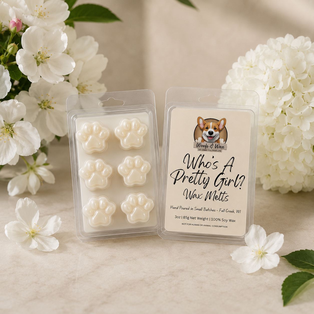 Pack of wax melts with a dog illustration and text, surrounded by white flowers on a beige background