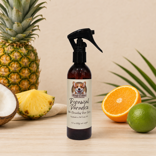 Spray bottle labeled 'Tropical Paradise' with pineapple, orange, and lime on a wooden surface.