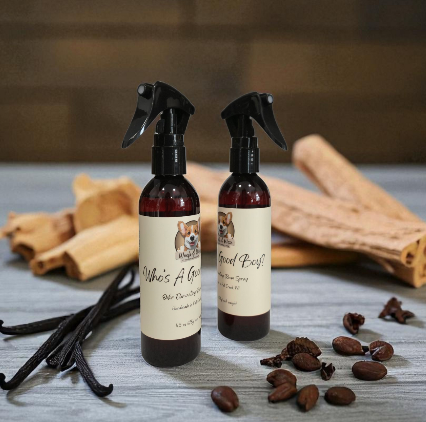 Two spray bottles with labels on a wooden surface with sandalwood and vanilla beans.