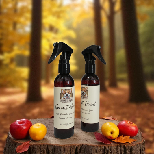Two spray bottles labeled 'Harvest Hound' on a wooden stump with apples and pears in an autumn forest setting.