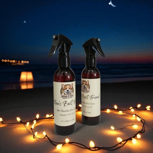 Two spray bottles with labels on a beach at night with string lights.